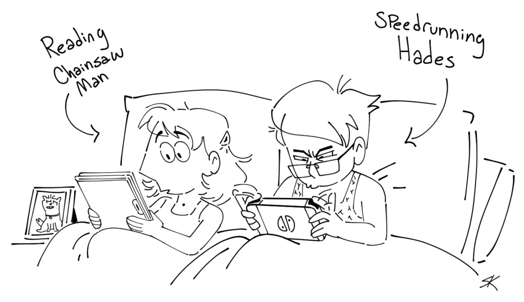 Two women reading in bed.