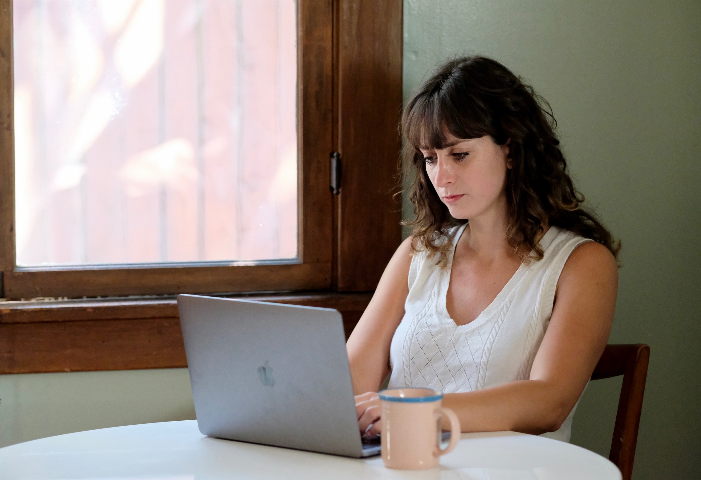 Woman writing on laptop