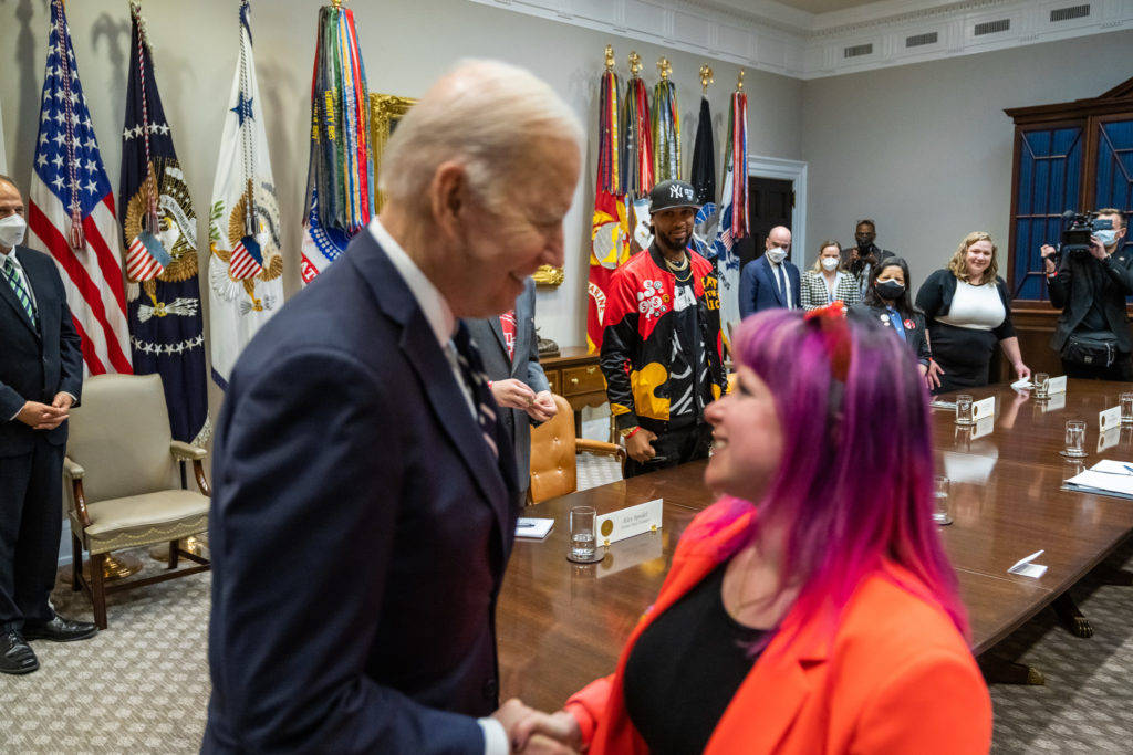 President Joe Biden shaking woman's hand