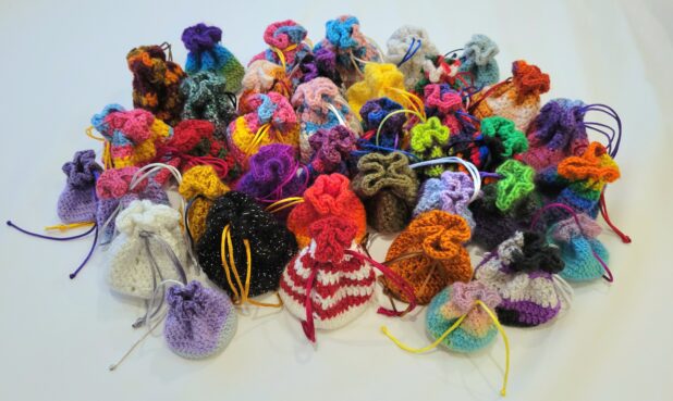 TITLE: BECCA’S BITTY BAGS SIZE:  Standard approx. 3.5” height x 3” diameter, Mini 2.5” H x 2.25” diameter DESCRIPTION: Crocheted with acrylic or polyester yarn. Drawstrings acrylic silk.  PRICE: $10 - $15