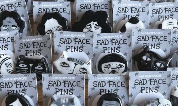 TITLE: HANDMADE SAD FACE PINS SIZE: Varies, approx. 2” x 1” x 0.5” DESCRIPTION: Clay and acrylic paint. PRICE: $30 each